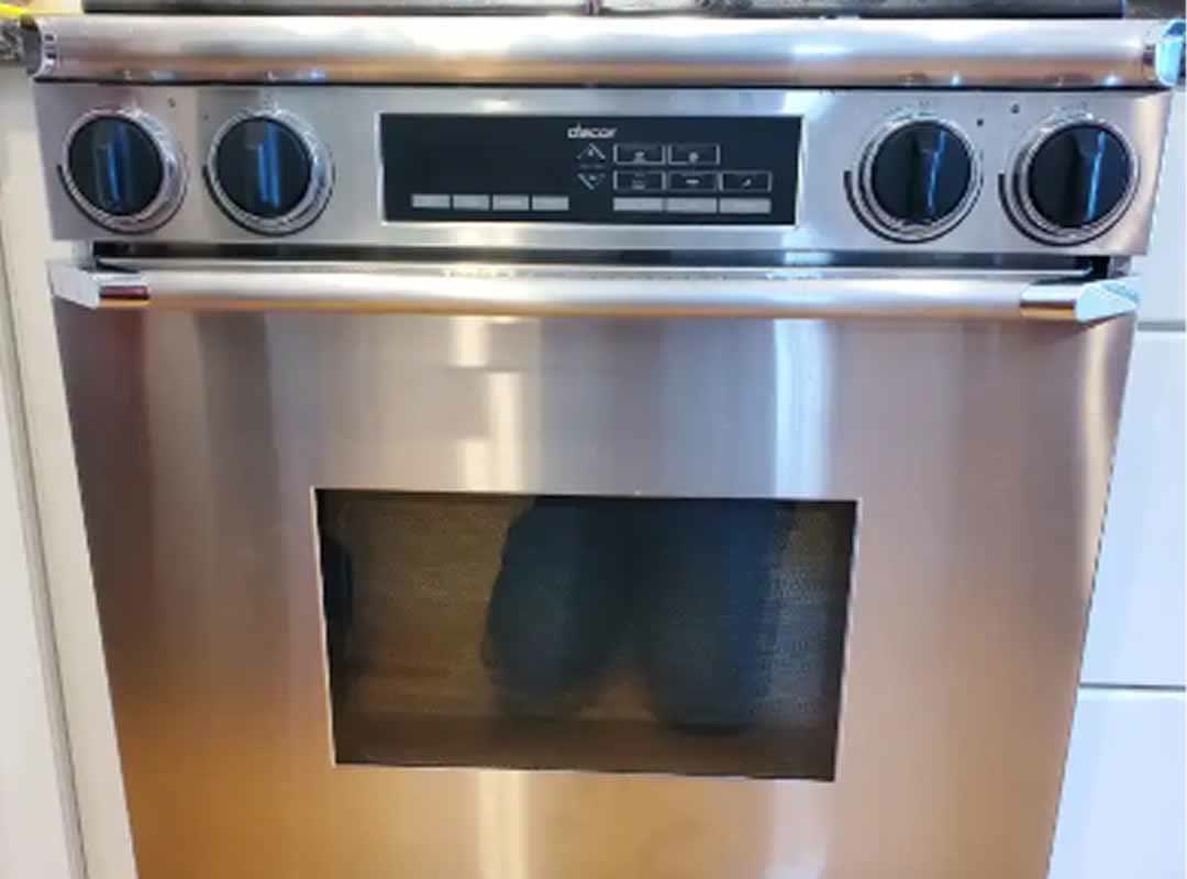 A stainless steel Dacor wall oven with its control panel and digital display, in a customer's kitchen